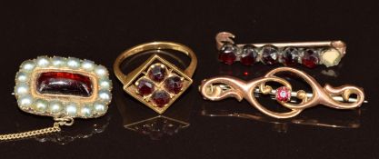 An 18ct gold ring set with four Bohemian cut garnets (3.1g, size K), two 9ct gold brooches (3.7g)