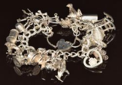 A silver charm bracelet with twenty charms including keys, Links of London '2000' in a heart,