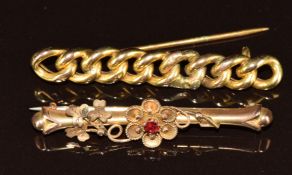 A yellow metal curb link brooch (damaged, 3.4g) and an Edwardian 9ct gold brooch (2.1g)