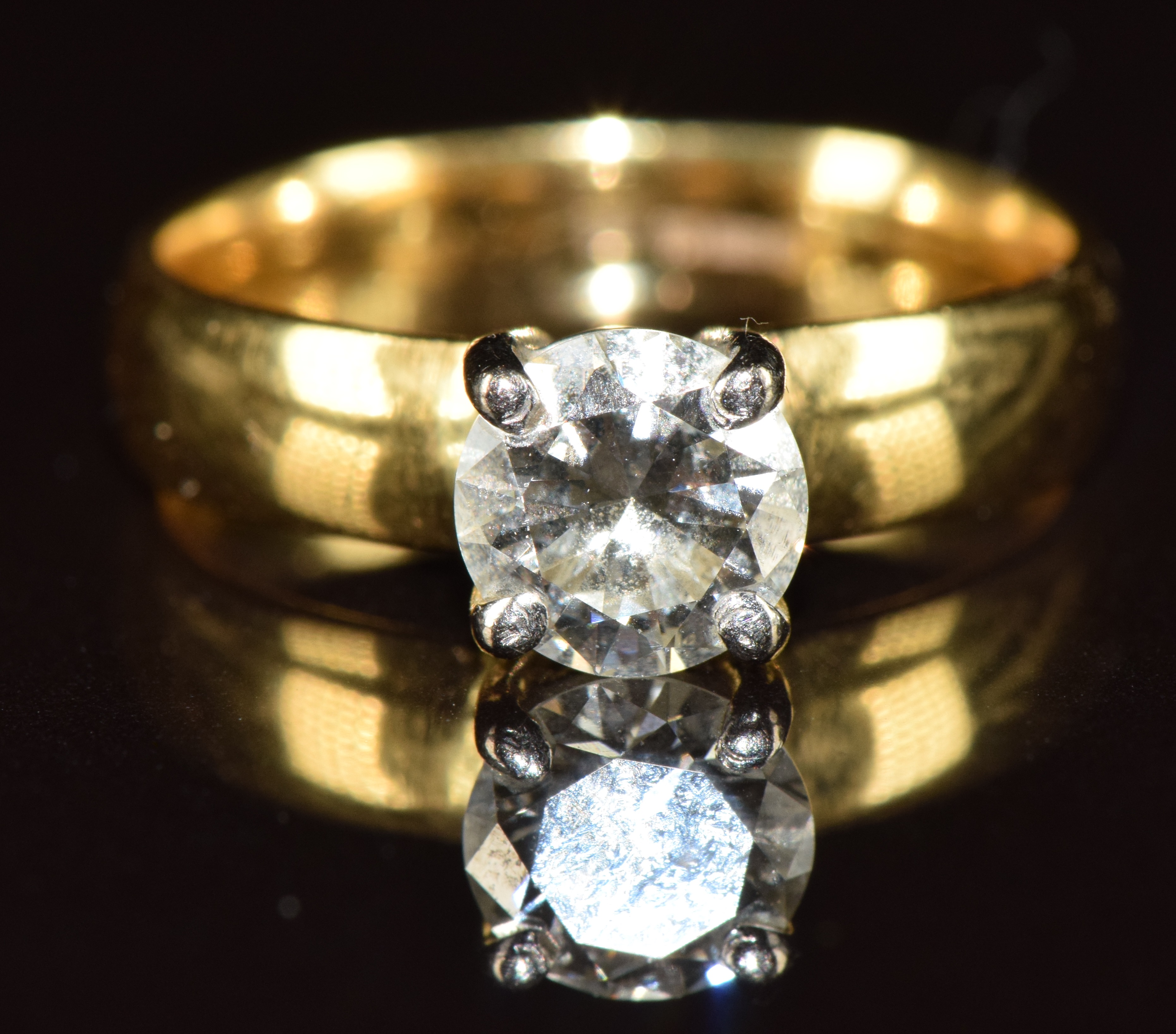 An 18ct gold ring set with a round brilliant cut diamond of approximately 0.9ct, 4.4g, size K