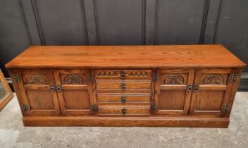 An 'Old Charm' oak low side cabinet, 183cm wide.