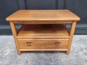 A pale Ercol corner television stand, with drop leaf rear flap, 71cm wide.