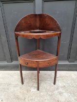 A George III mahogany corner washstand, 101cm high.