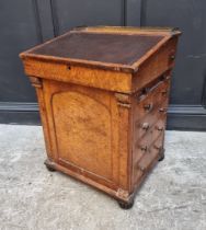 An early 19th century birds' eye maple Davenport, stamped 'Gillows Lancaster', 61cm wide.