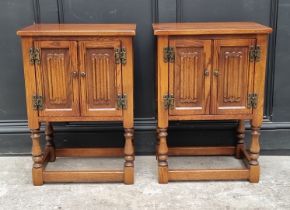 A pair of 'Old Charm' oak bedside cupboards, 50cm wide. (2)