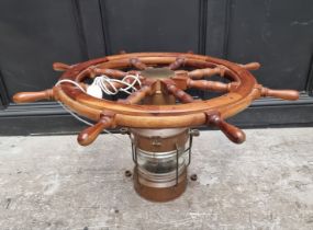 A novelty teak ship's wheel and copper lantern coffee table, with glass top, 100cm diameter.