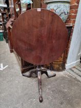 A George III mahogany circular tilt top tripod table, (restorations), 69cm diameter.