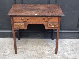 An 18th century oak lowboy, with shaped kneehole, 81cm wide.