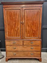 A George III mahogany and kingwood crossbanded linen press, enclosing hanging space, 142cm wide.