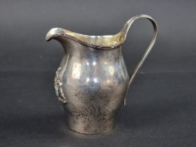 The Worshipful Company of Cutlers: an Edwardian crested silver milk jug, having gilt interior, by