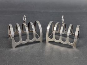 A pair of silver four division toast racks, by Charles S Green & Co Ltd , 7.7cm long, 89g.