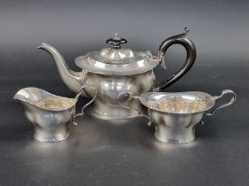 An Edwardian silver three piece bachelor's tea set, by Jones & Crompton, Birmingham 1910, gross