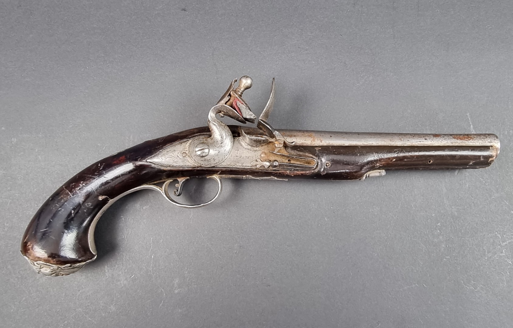 An 18th century silver mounted flintlock holster pistol, by T. Richards, Birmingham, probably