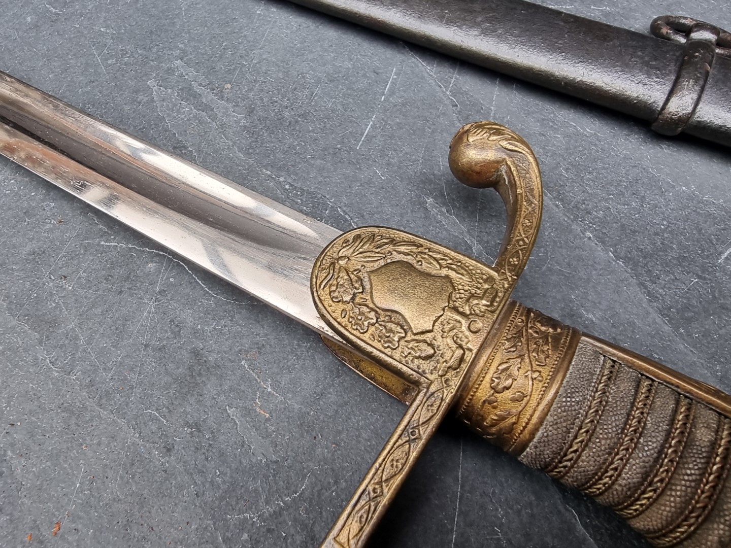 A German Imperial officer's lionhead sabre and steel scabbard, having 76cm fullered blade. - Image 4 of 7