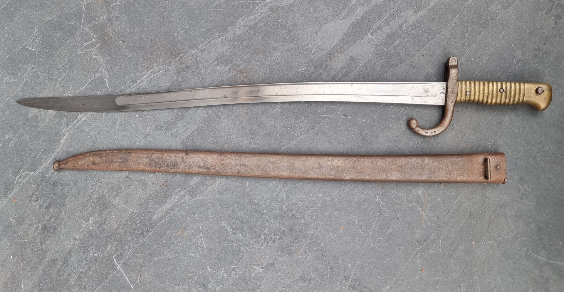 A French M1866 pattern chassepot sword bayonet and scabbard, the 57cm blade engraved 'St Etienne