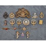 A WWI Bavarian M1896 pattern brass Pickelhaube front plate; and various UK cap badges and
