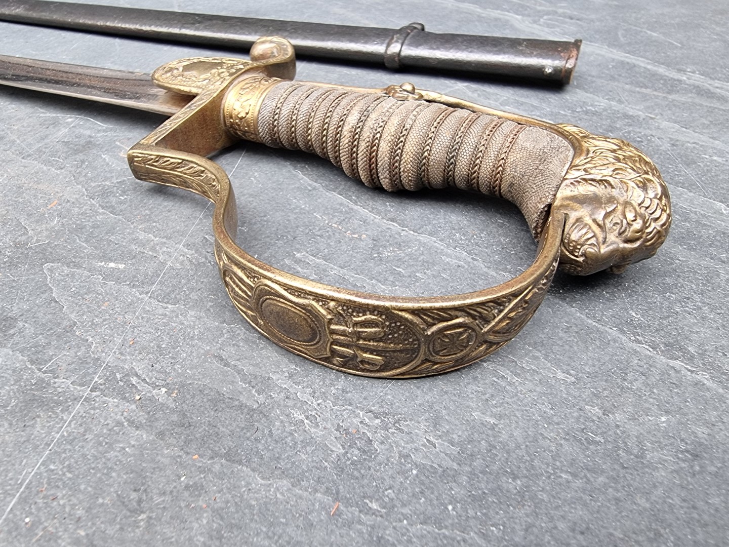 A German Imperial officer's lionhead sabre and steel scabbard, having 76cm fullered blade. - Image 3 of 7