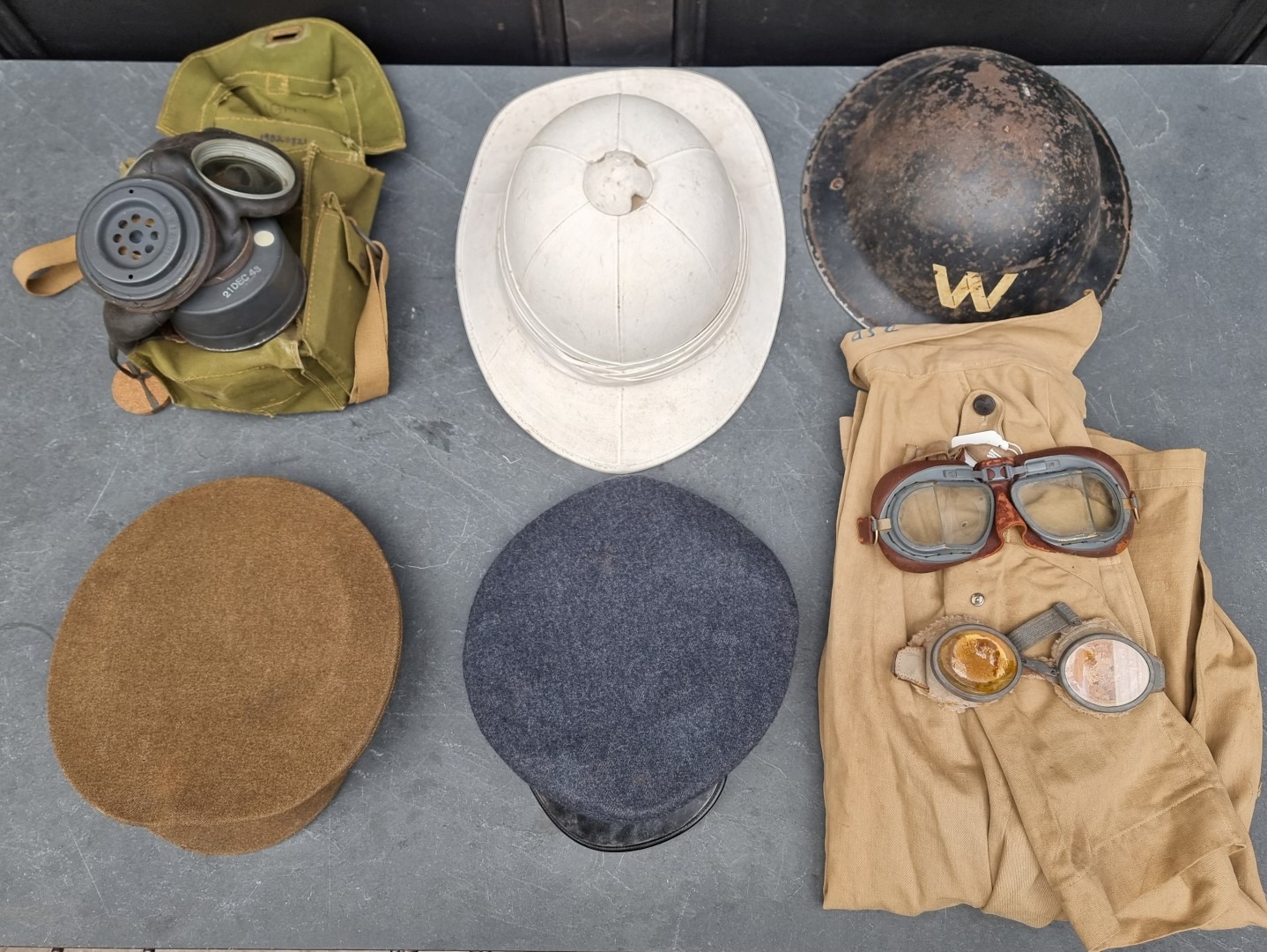 A group of militaria; comprising a British gas mask, dated 1943; an RAF officer's peaked cap; an ARP