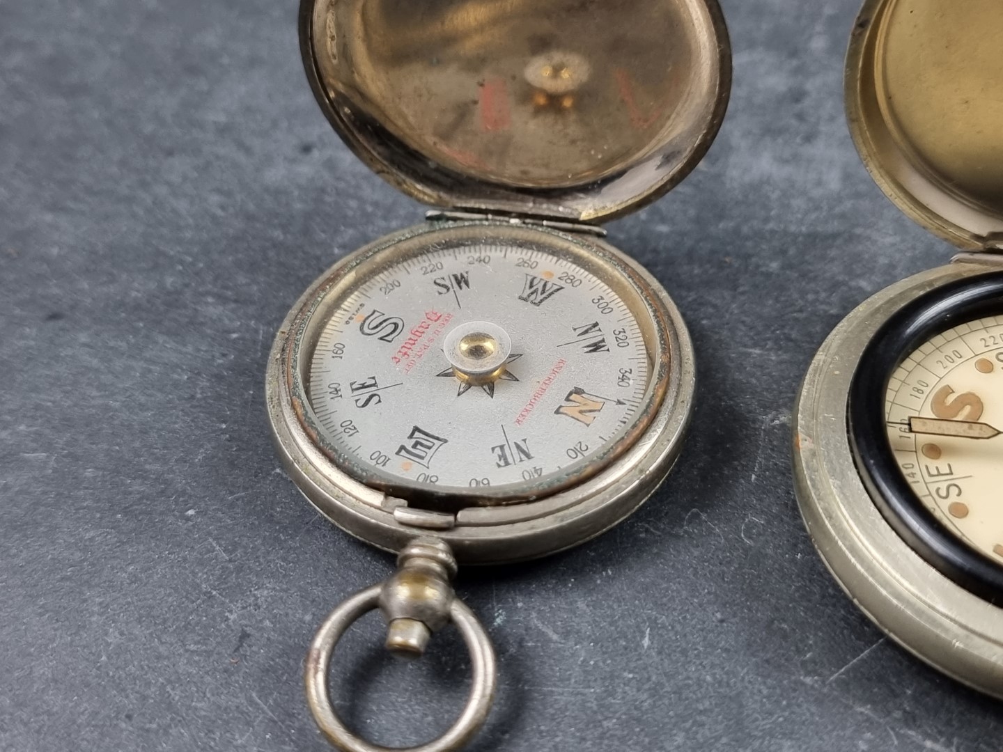 Two WWI military style nickel plated compasses; together with two other pocket compasses. (4) - Image 2 of 5