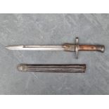 An Italian M1891 Carcano bayonet and scabbard, the 29cm blade marked 'Terni' to the ricasso and