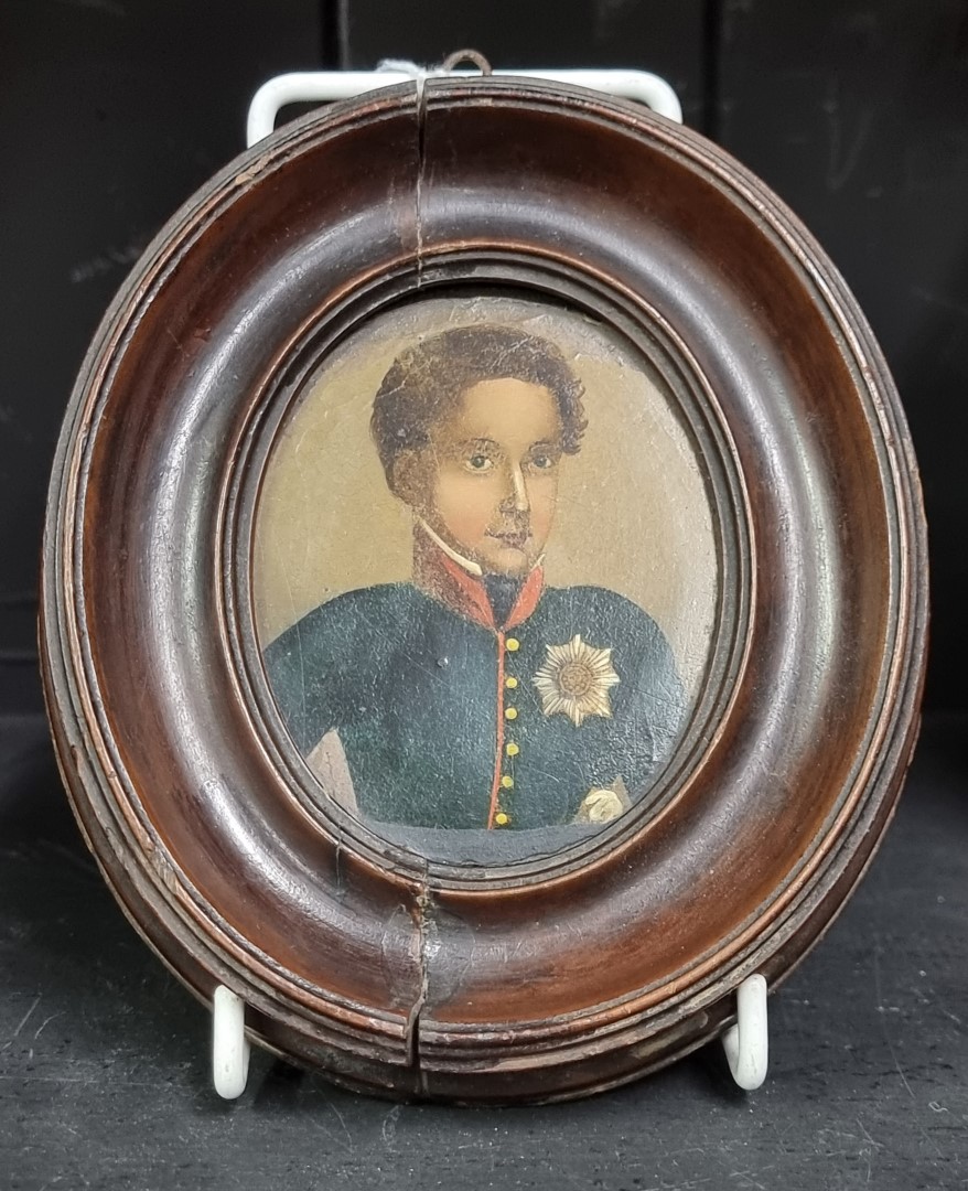 A 19th century Russian portrait miniature of a young man in uniform, wearing The Order of The