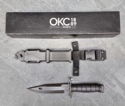 An Ontario Knife Co. 'M9' knife and sheath, having 18cm blade, boxed.