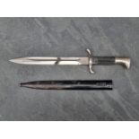 A German WWII fire police dress bayonet and scabbard, distributed by Linnenbrugger & Ellerman of