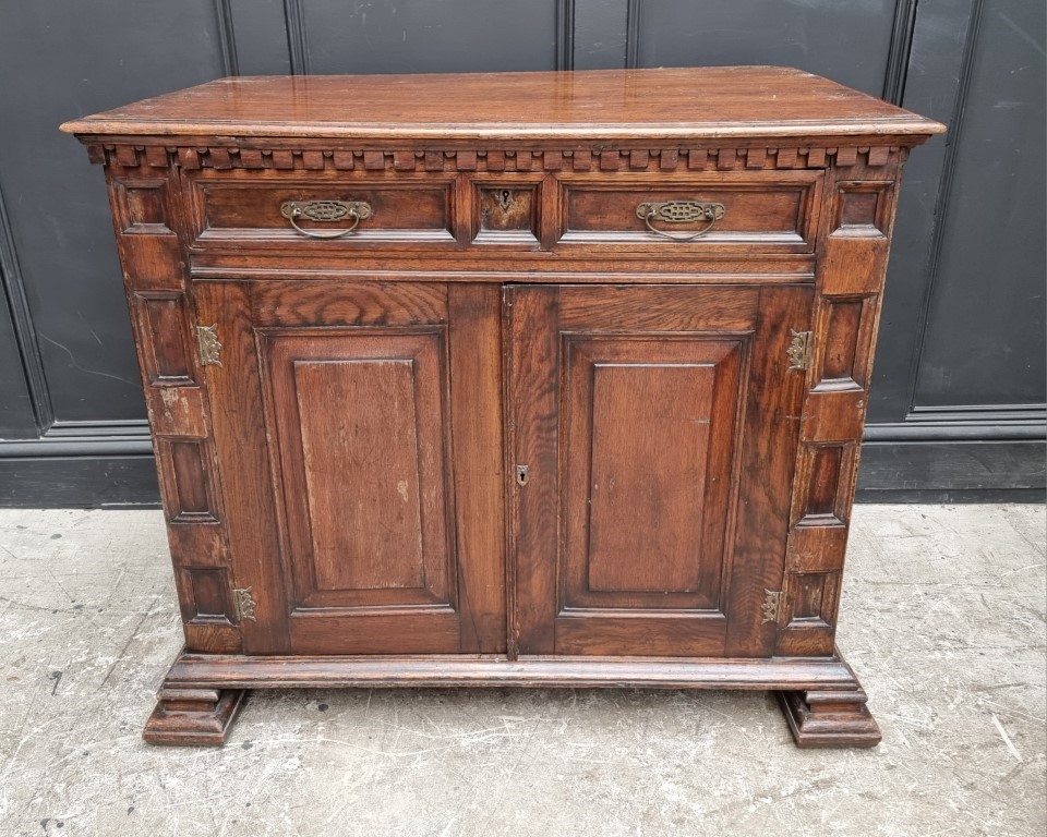 An antique oak panelled side cabinet, 102.5cm wide.