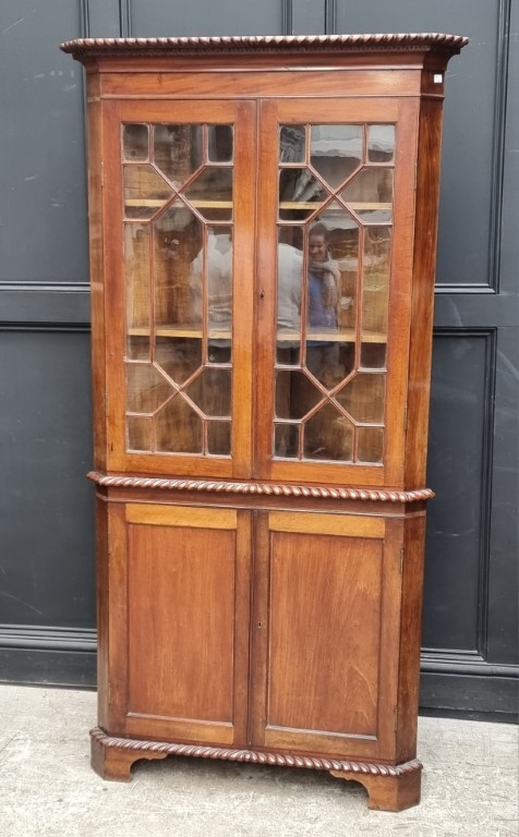 An old mahogany standing corner cupboard, 98cm wide.