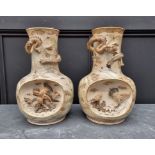 An unusual pair of Japanese Satsuma pottery vases, Meiji, 36cm high, (losses). (2)