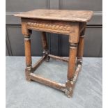 A 17th century carved oak joint stool, 49cm wide.