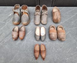 A collection of antique miniature shoes.