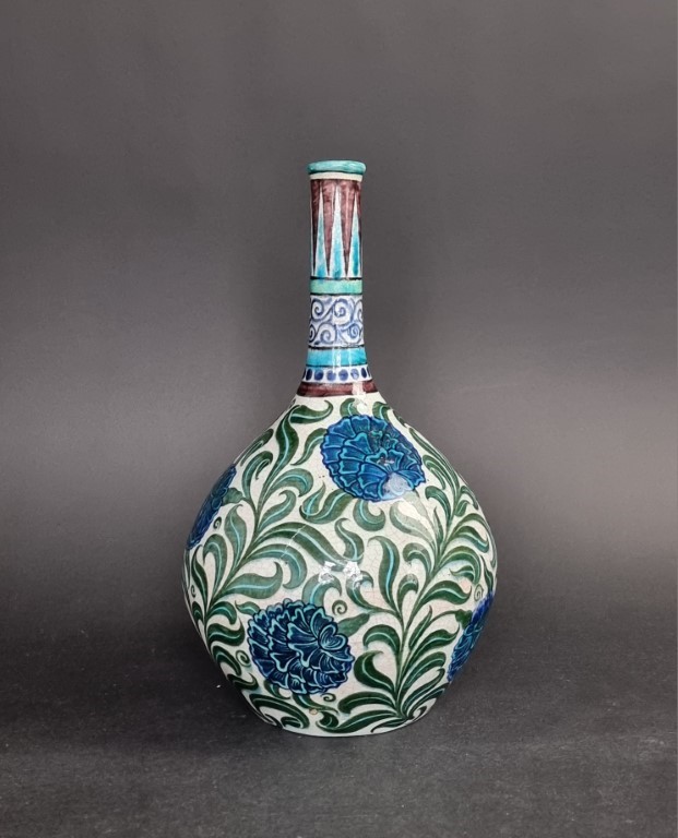 A William de Morgan pottery bottle vase, painted with Persian style flowers, 32cm high.