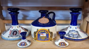 Two pairs of Pusser's rum decanters and stoppers, largest 22cm high; and a similar flagon. (5)