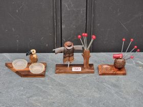 A rosewood cocktail stick stand, 14cm wide; together with another; and one other similar item. (3)