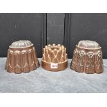 Three antique copper jelly moulds, largest 14cm high. (3)