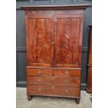 A large George IV mahogany linen press, possibly Scottish, with five sliding trays and bone