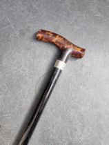 A tortoiseshell handled silver mounted ebonised walking stick.