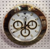 A Rolex style wall clock, 34cm diameter.