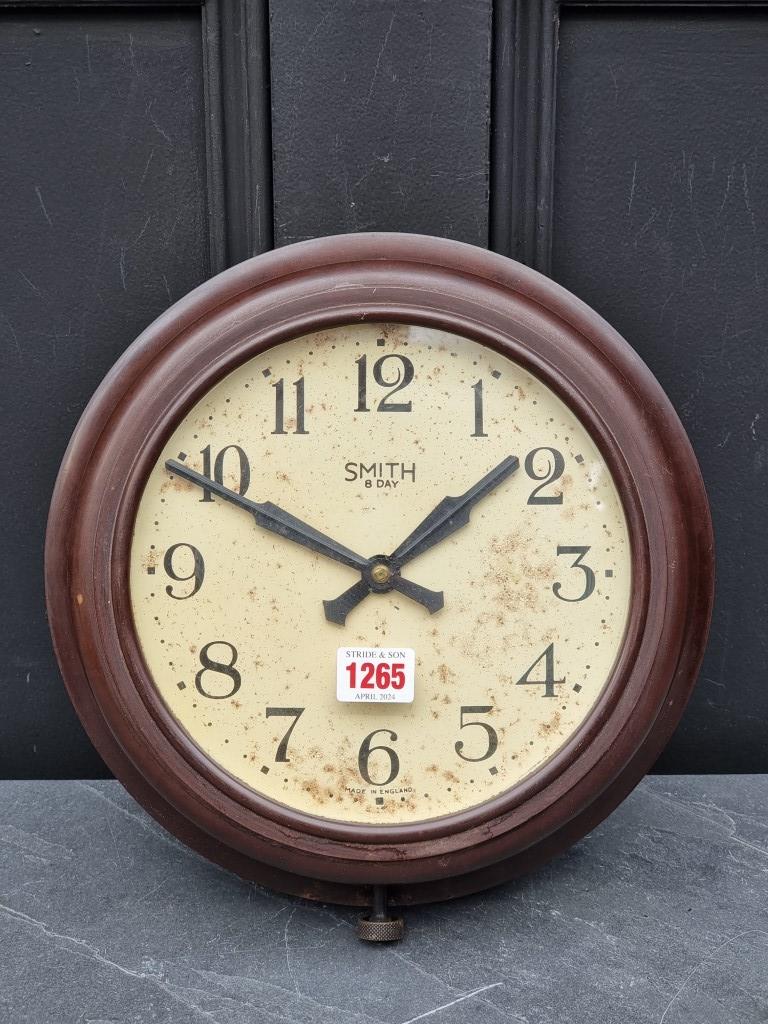 A Smith brown Bakelite eight day wall clock, 29cm diameter.