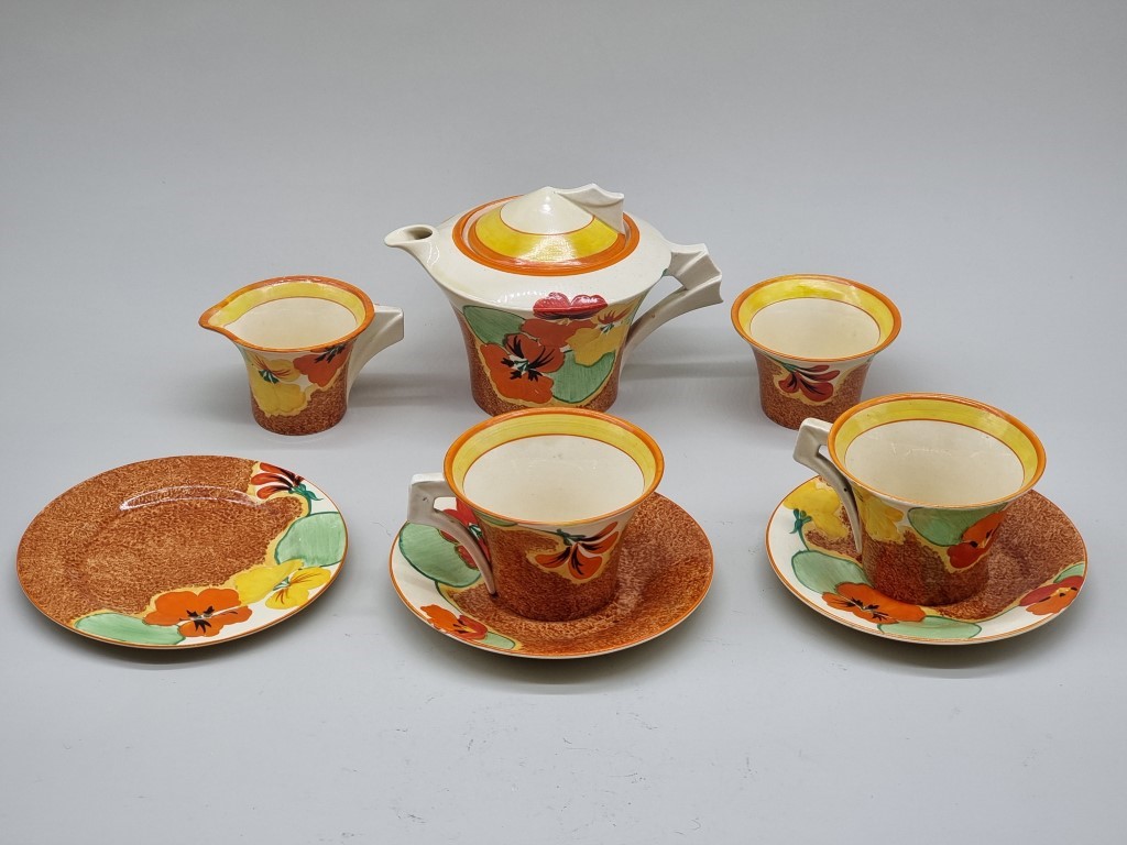 A Clarice Cliff 'Nasturtium' pattern Daffodil shape tea for two set, the teapot & cover 12cm high.