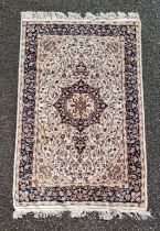 A Persian rug, having central floral medallion, with floral borders, 202 x 127cm.