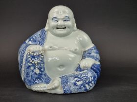 A large Chinese blue and white Buddha, impressed mark to base, 27cm high.