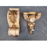 A carved wood and polychrome painted cherub wall bracket, 32cm high; together with another corbel