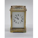 An old brass carriage timepiece, height including handle 18cm.