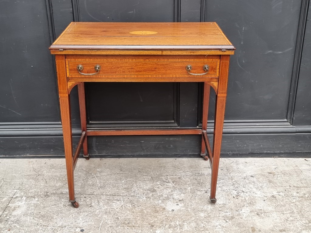An Edwardian mahogany and inlaid writing desk, with foldover top, 69cm wide.