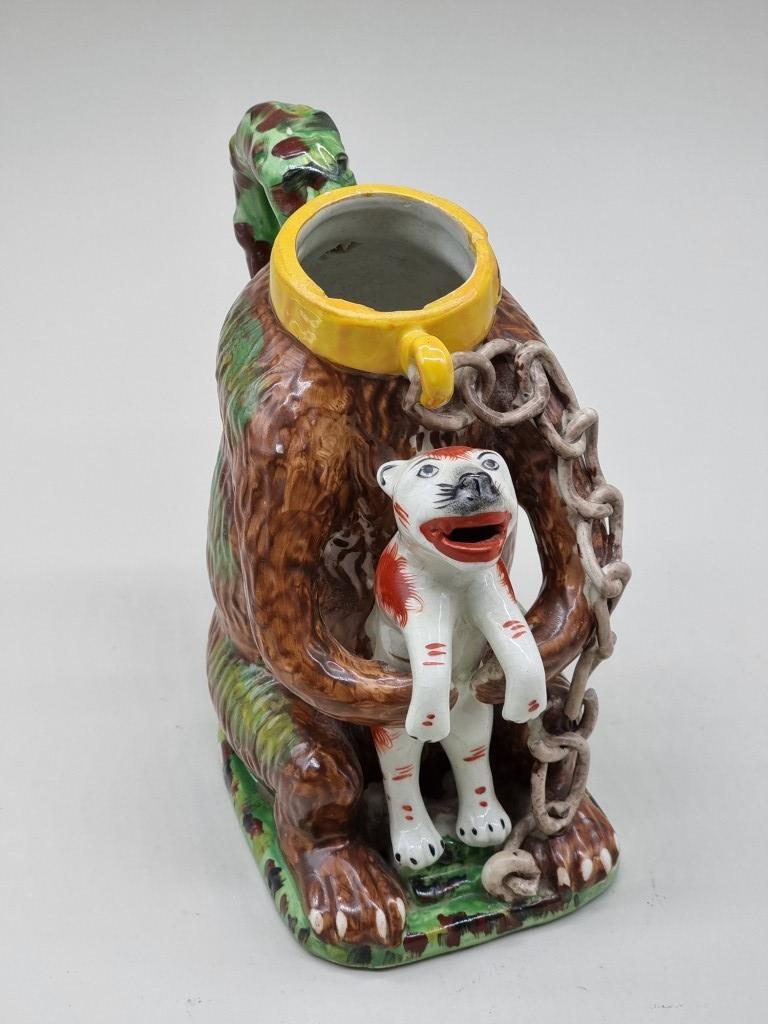 A reproduction Staffordshire style 'Bears Grease' jug and cover, 29cm high. - Bild 2 aus 3