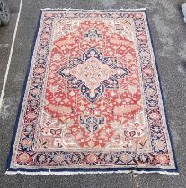 A large carpet, having central star medallion, with floral cartouches to each corner, with floral