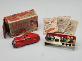 Schuco: a vintage red Schuco Telesteering car 3000, with box, key, instructions and accessories.