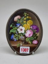 A Continental porcelain floral painted plaque, 14.5 x 11cm oval.